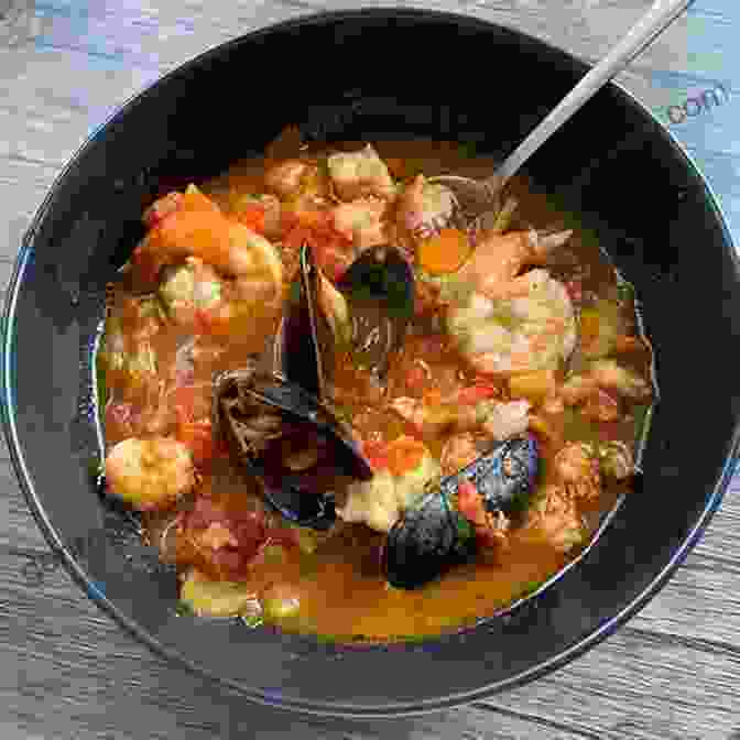 A Close Up Of A Bubbling Pot Of Seafood Stew, Filled With Shrimp, Scallops, Mussels, And Vegetables Martha S Vineyard Cookbook: Over 250 Recipes And Lore From A Bountiful Island